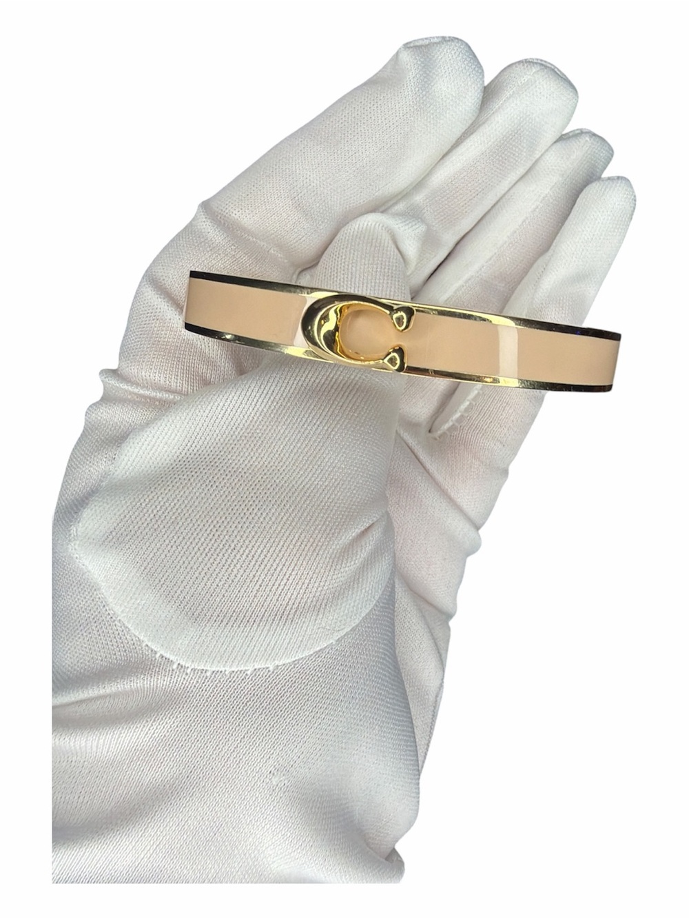 Coach Signature Push Hinged Bangle gold-plated design with blush pink enamel